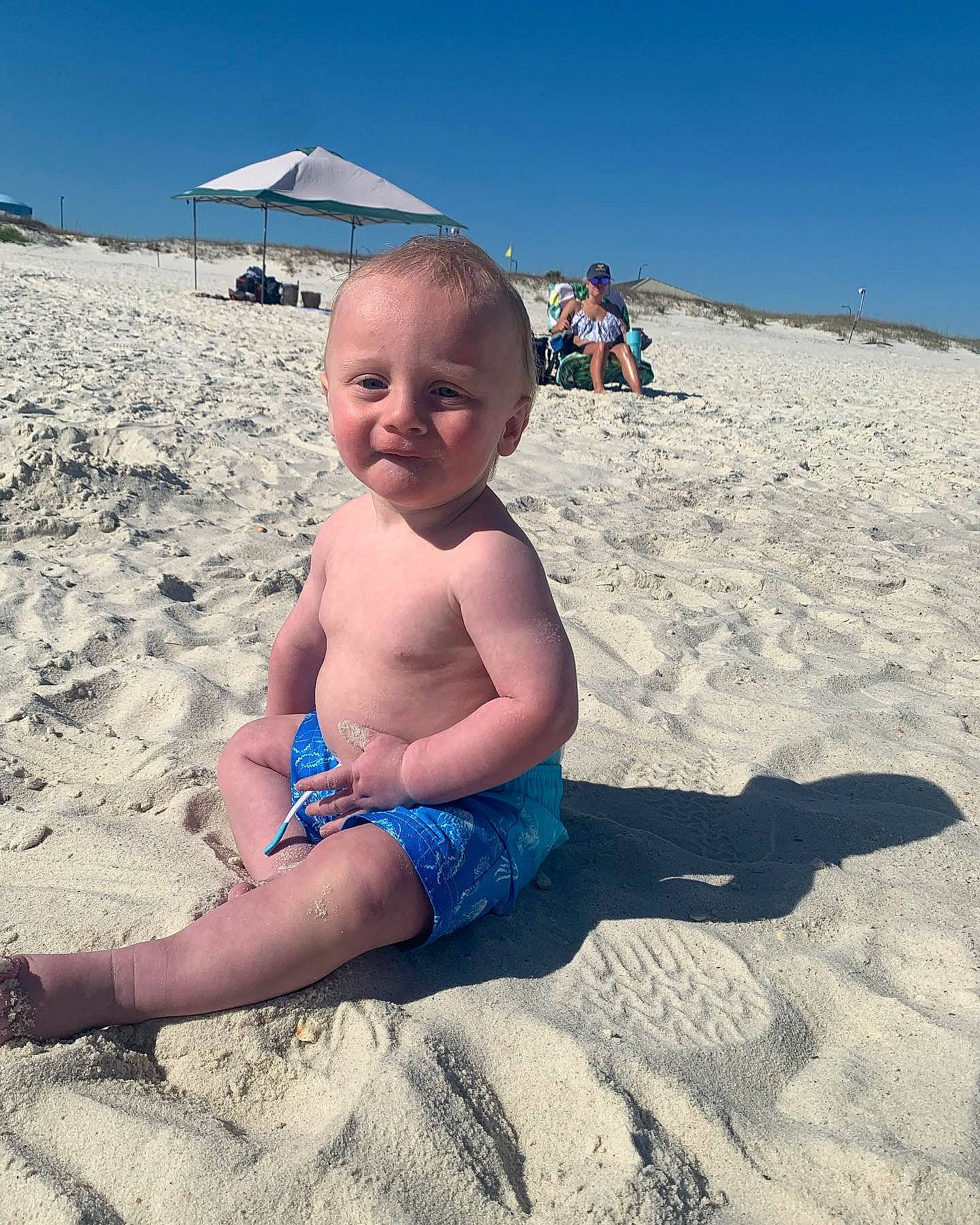Kylin is registered to the contest to win money with this photo: azure, baby, beach, body_of_water, child, fun, happy, human_body, leisure, natural_environment, people_in_nature, people_on_beach, person, shorts, sky, smile, summer, thigh, toddler, travel