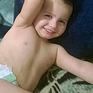 Nathaniel joined the competition — help win amazing prizes! child, toddler, smiling, diaper, bare_chest, lying_down, blanket, hair_spiked, happy, relaxed, indoor, person, young_child, skin, face, arm, gesture, comfort, candid, casual