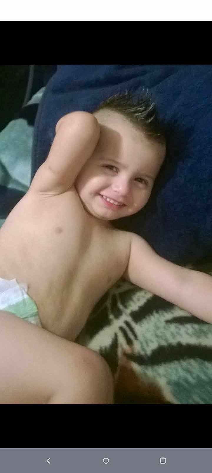 Nathaniel joined the competition — help win amazing prizes! child, toddler, smiling, diaper, bare_chest, lying_down, blanket, hair_spiked, happy, relaxed, indoor, person, young_child, skin, face, arm, gesture, comfort, candid, casual