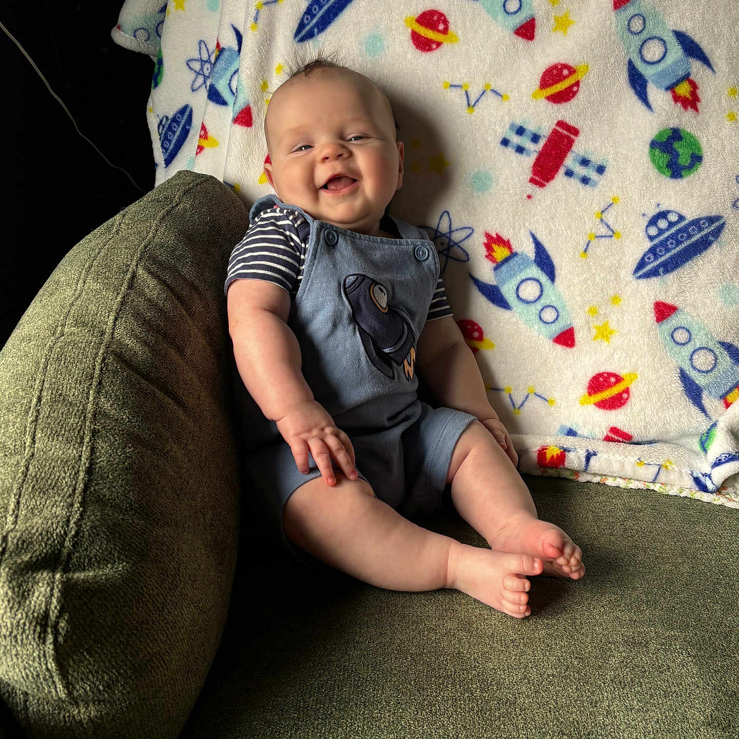 Ruben is registered to the contest to win money with this photo: baby, babylaughing, bodypart, clothing, couch, cushion, face, finger, furniture, hand, happy, head, homedecor, newborn, pants, person, photography, portrait, sitting, smile