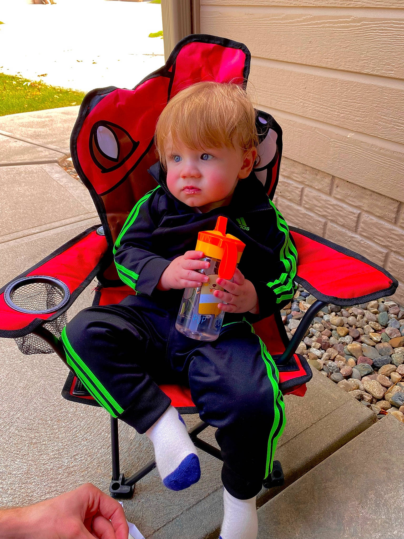 Kaden joined the competition — help win amazing prizes! baby, baby_carriage, baby_products, baby_toddler_clothing, chair, child, event, face, facial_expression, fun, grass, lap, leg, leisure, person, personal_protective_equipment, recreation, shoe, sitting, sneakers