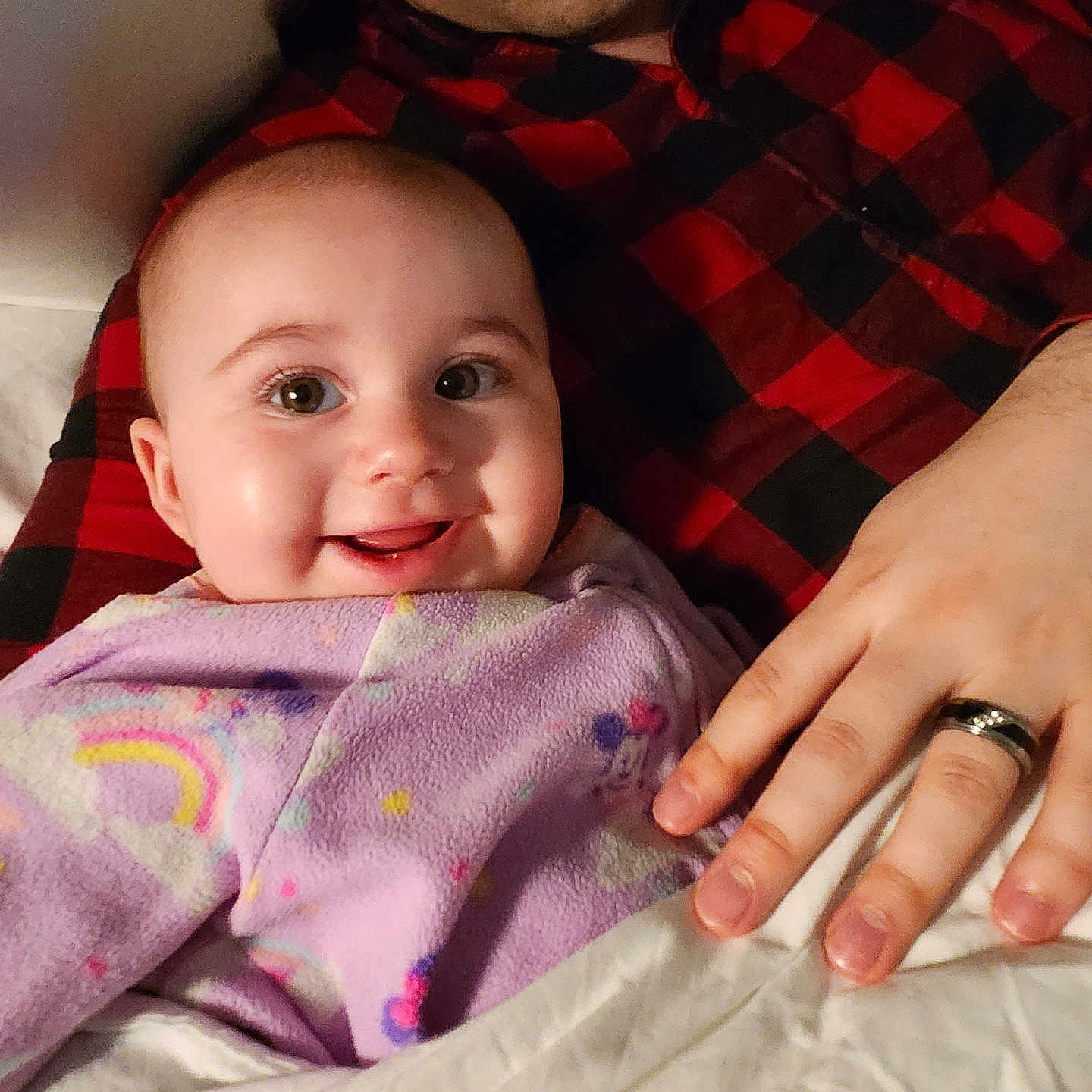 Amitalyriea joined the competition — help win amazing prizes! baby, smiling, adult, blanket, purple, red_and_black_shirt, hand, bed, cozy, happy, person, portrait, indoor, face, skin, cute, infant, child, clothing, family