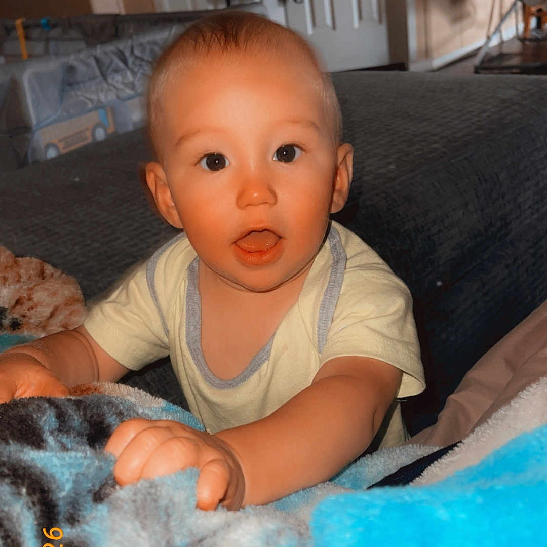 Stetson joined the competition — help win amazing prizes! baby, infant, child, blanket, indoor, curious, face, expression, hand, furniture, door, room, carpet, clothing, person, portrait, candid, lighting, home, young