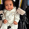 Ahsai is registered to the contest to win money with this photo: baby, buttoned_shirt, car_seat, child, closeup, curly_hair, cute, fabric, happy, indoor, infant, person, portrait, safety_label, seatbelt, smiling, toy, vest, white_clothing, young_child