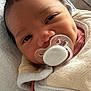 baby, pacifier, blanket, pink_clothing, face, infant, closeup, cute, sleeping_area, soft_texture, newborn, head, skin, eyelashes, indoors, person, portrait, resting, cozy, young_child