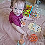 toddler, child, glasses, smile, toy, blanket, indoor, floor, sitting, happy, playtime, person, baby, wood, furniture, colorful, plastic, head, face, clothing