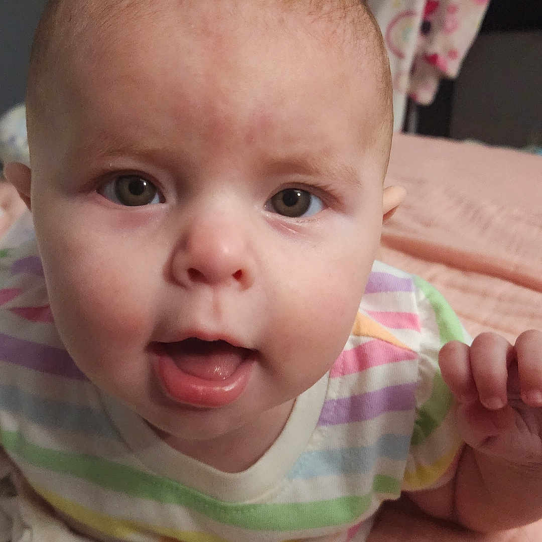 Cassidy joined the competition — help win amazing prizes! baby, bed, bodypart, couch, face, finger, frown, furniture, hand, happy, head, mouth, newborn, person, photography, portrait, quilt, sad, sitting, smile