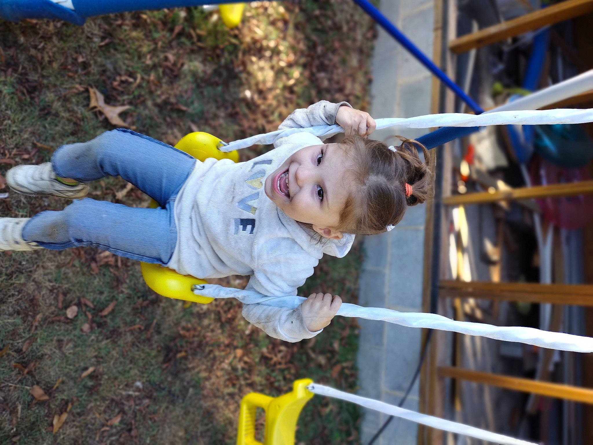 Maggie joined the competition — help win amazing prizes! baby, child, city, fun, grass, happy, joy, leisure, outdoor_play_equipment, person, play, playground, recreation, sleeve, smile, soil, swing, toddler, tree, yellow