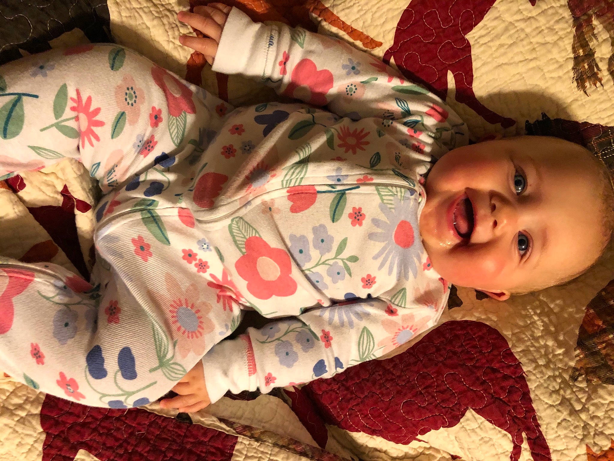 Mila is registered to the contest to win money with this photo: baby, bedding, bedtime, carmine, child, comfort, couch, flesh, happy, linens, pattern, person, plaid, room, sitting, skin, smile, textile, toddler, tradition