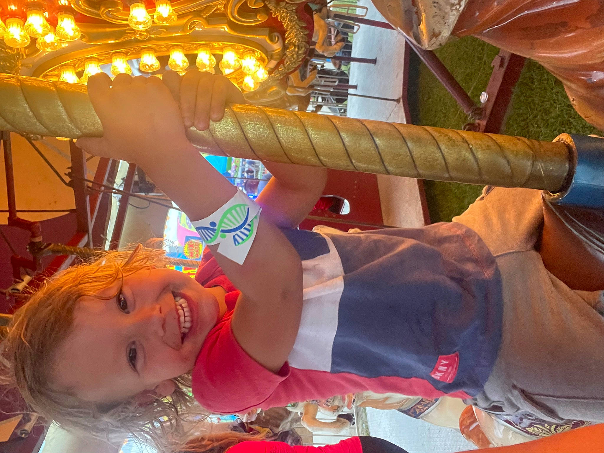 Hayden is registered to the contest to win money with this photo: abdomen, amusement_ride, child, elbow, event, fun, happy, human_leg, jewellery, joy, leisure, musical_instrument, pattern, person, recreation, smile, temple, thigh, tradition, tree