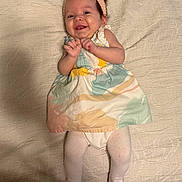 Harper joined the competition — help win amazing prizes! baby, smiling, headband, dress, tights, infant, lying_down, blanket, cute, happy, portrait, pastel_colors, child, indoor, young_child, clothing, person, baby_girl, fabric, soft_texture