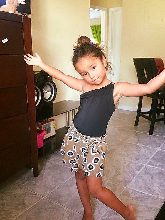 Yasmin is registered to the contest to win money with this photo: abdomen, arm, child_model, clothing, day, dress, girl, hip, joint, leg, miniskirt, muscle, neck, pattern, person, product, shorts, shoulder, thigh, trunk