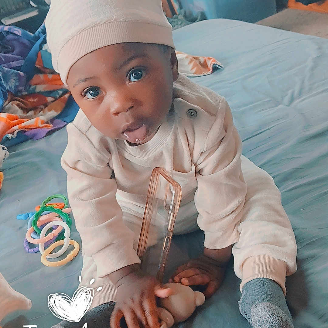 Kash'Mire joined the competition — help win amazing prizes! baby, bed, bedroom, blanket, blue_bedspread, bookshelf, child, hat, infant, onesie, phone_case, pikachu, sock, storage_bin, stuffed_toy, teether, text_overlay, timestamp_overlay, toy_rings, wide_eyes