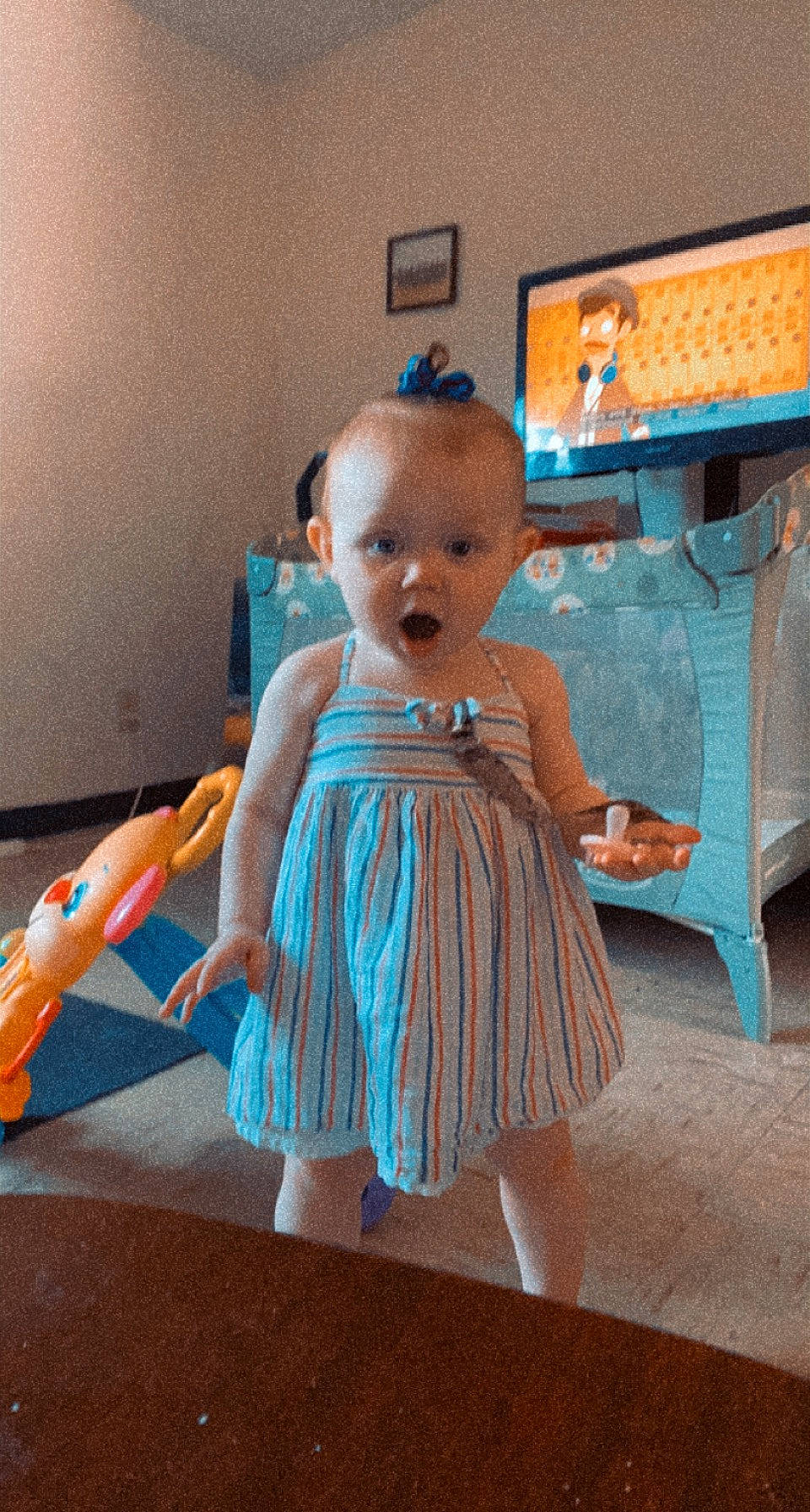 Aubriella joined the competition — help win amazing prizes! baby_toddler_clothing, chair, child, computer_keyboard, computer_monitor, day_dress, dress, electric_blue, floor, flooring, fun, input_device, leg, person, sitting, standing, surprise, television, textile, toddler