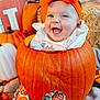 baby, pumpkin, orange_bow, fall, autumn, happy, smiling, costume, festive, decorations, blanket, cute, child, holiday, seasonal, portrait, indoors, colorful, playful, fun