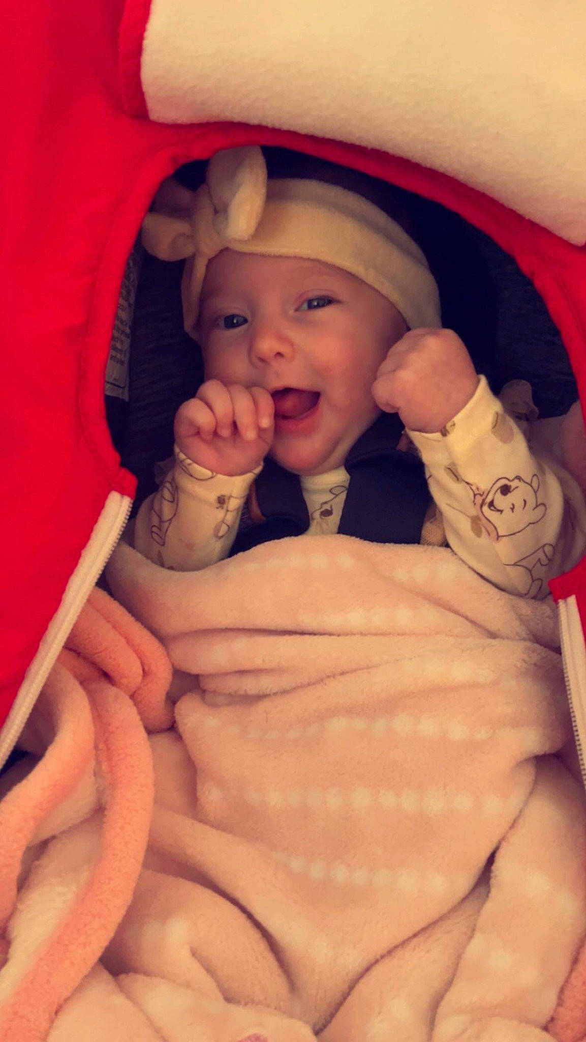 Stella is registered to the contest to win money with this photo: arm, baby, cheek, chin, comfort, eye, eyelash, facial_expression, finger, gesture, hand, headwear, lip, mouth, muscle, nose, organ, person, product, skin