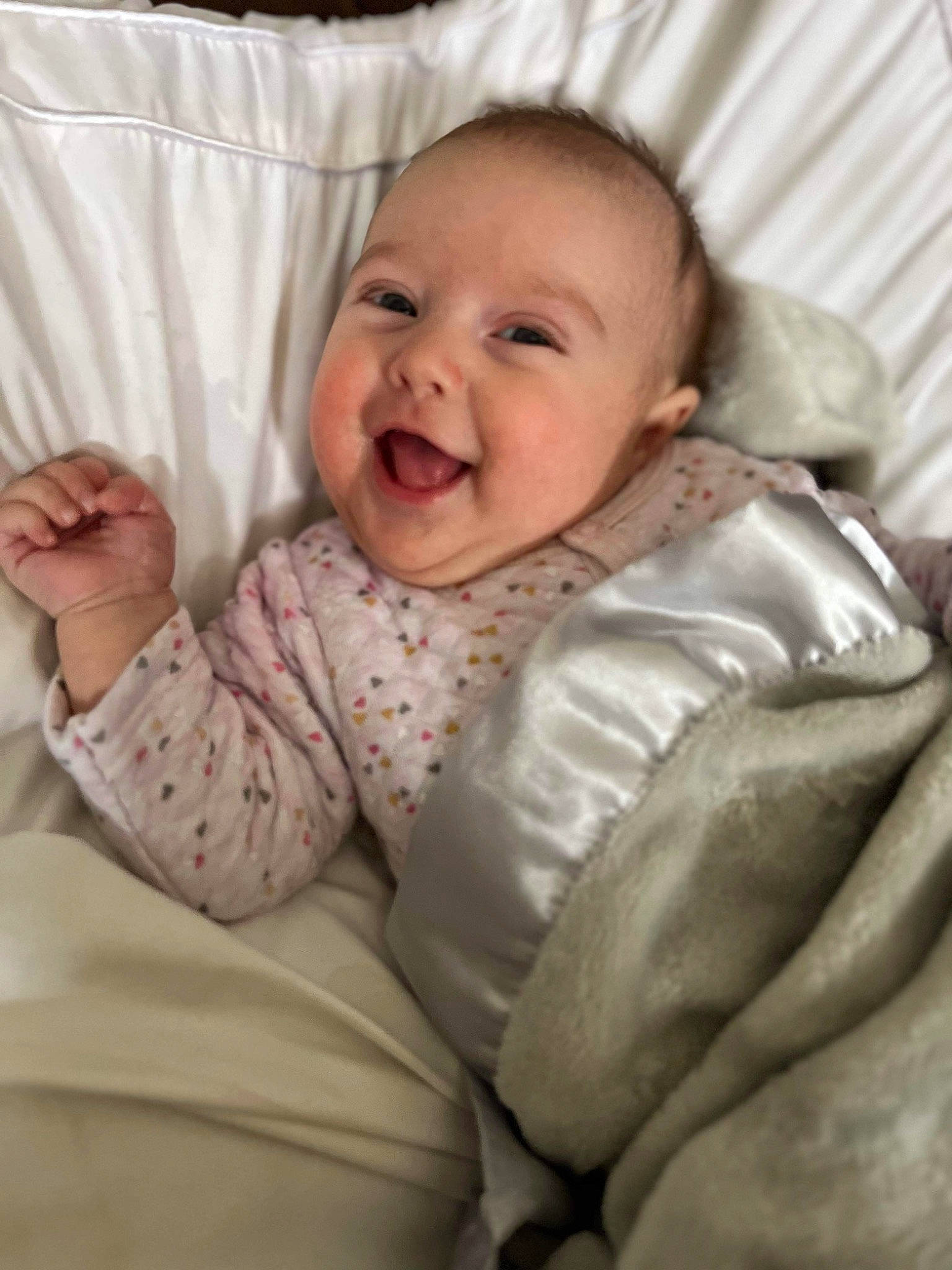 Stella is registered to the contest to win money with this photo: baby, baby_laughing, baby_toddler_clothing, cheek, child, collar, comfort, eye, face, fun, gesture, happy, head, joy, linens, person, room, sitting, sleeve, smile