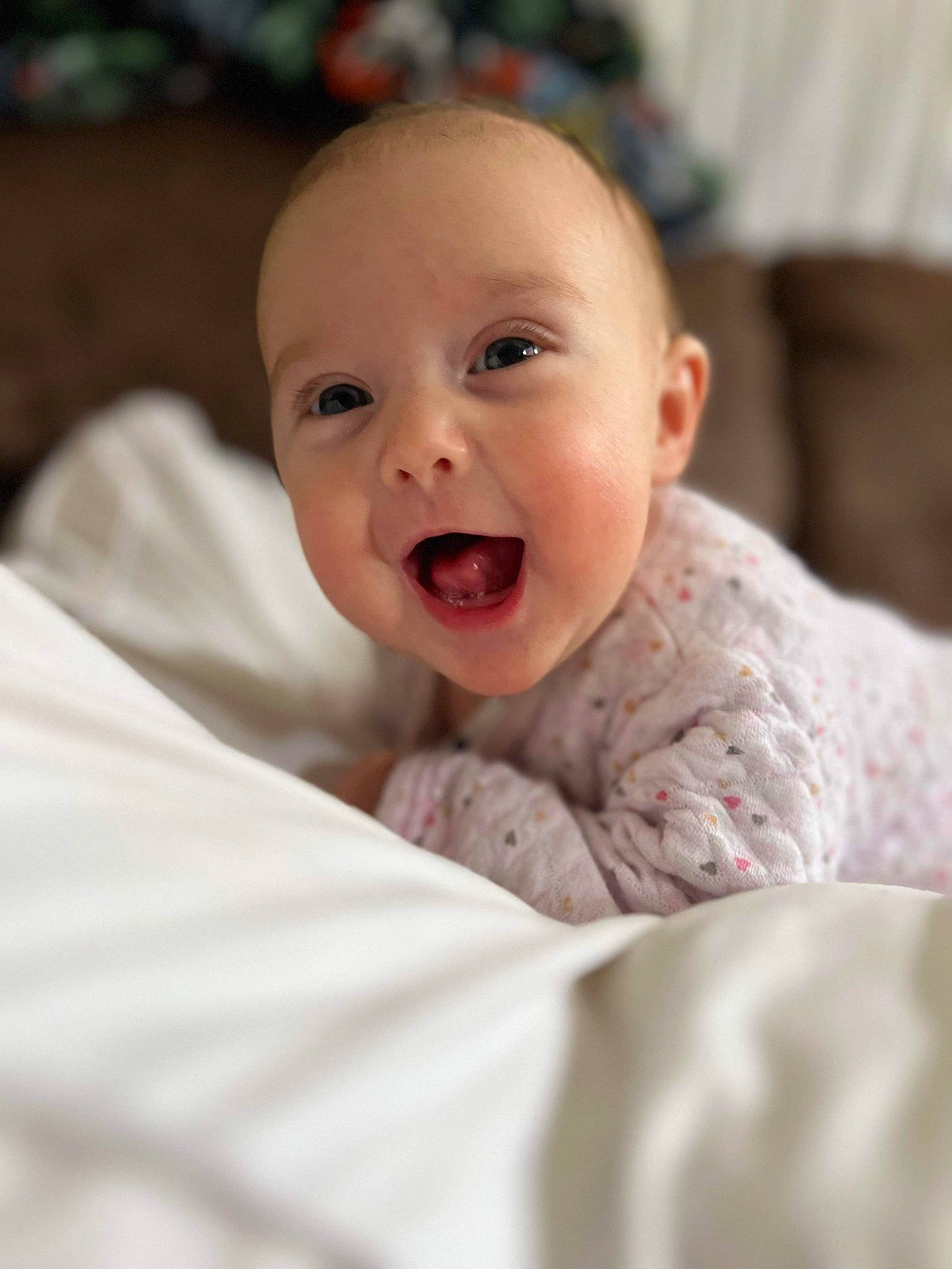 Stella joined the competition — help win amazing prizes! baby, baby_toddler_clothing, bedding, cheek, comfort, fun, fur, happy, human_body, iris, laugh, linens, lip, nose, person, portrait_photography, sitting, sleeve, smile, toddler