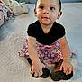Abigail is registered to the contest to win money with this photo: toddler, child, baby, sitting, shoes, blanket, pink_skirt, black_top, indoor, carpet, cute, portrait, hand, face, expression, clothing, floor, person, room, curious