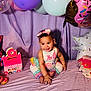 Kaleigha is registered to the contest to win money with this photo: baby, child, smile, balloons, donut, decoration, purple, bow, outfit, sitting, party, celebration, cute, happy, indoor, colorful, posing, face, infant, playful