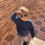 Adam a rejoint le concours — aidez-le/la à gagner de superbes lots ! child, boy, sunglasses, blue_sweater, grey_pants, black_shoes, standing, indoor, tiled_floor, brick_wall, sunlight, shadow, posing, casual_clothing, hair, reflection, young, fashion, person, portrait