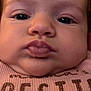 baby, face, close_up, child, expression, pink_shirt, wet_hair, pout, chubby_cheeks, portrait, person, infant, cute, skin, eyebrows, eyes, clothing, mouth, nose, young