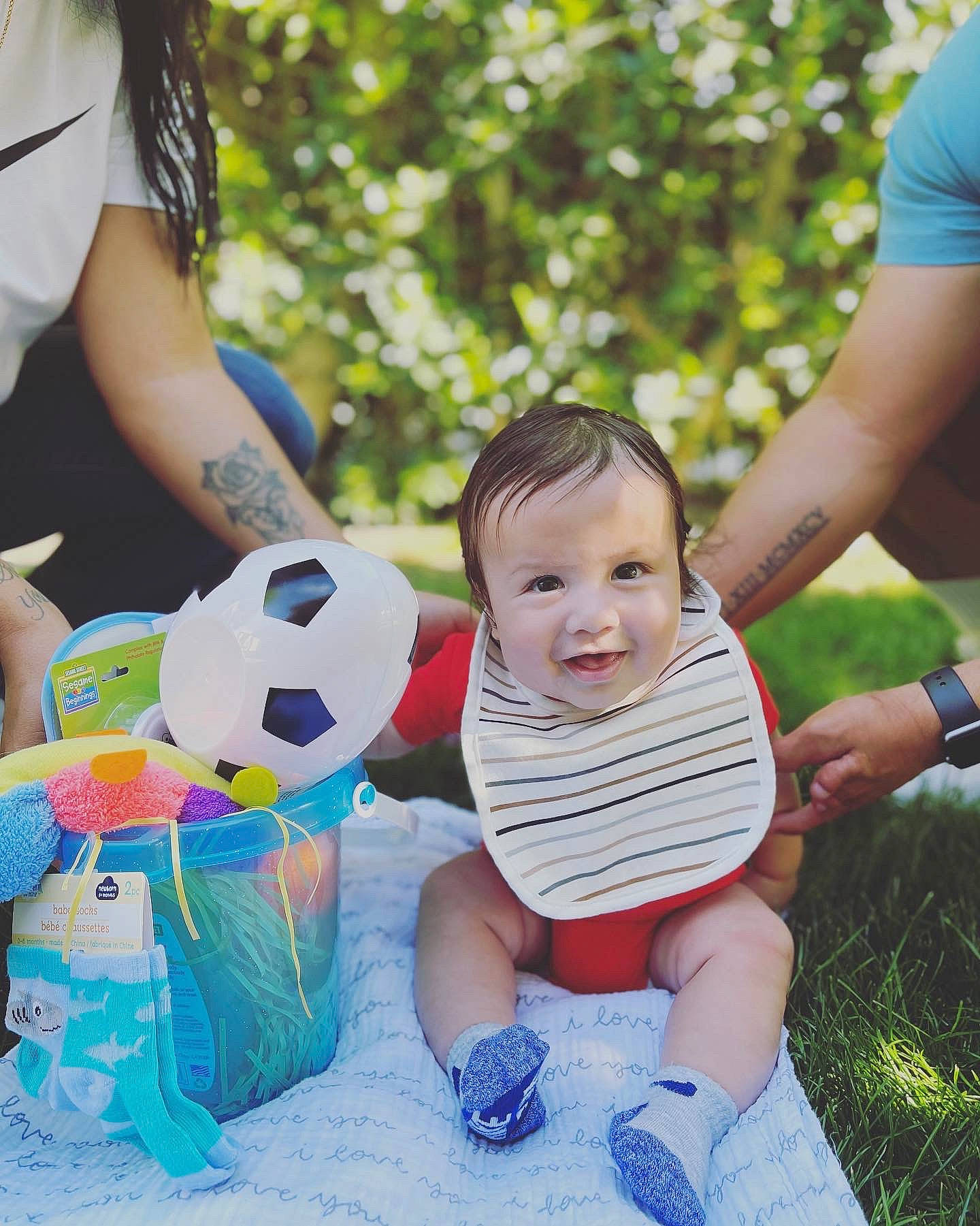 Cassius is registered to the contest to win money with this photo: baby_toddler_clothing, football, fun, grass, happy, leg, leisure, mammal, people, people_in_nature, person, photograph, playing_with_kids, product, shoe, shorts, smile, soccer, sports_equipment, toddler