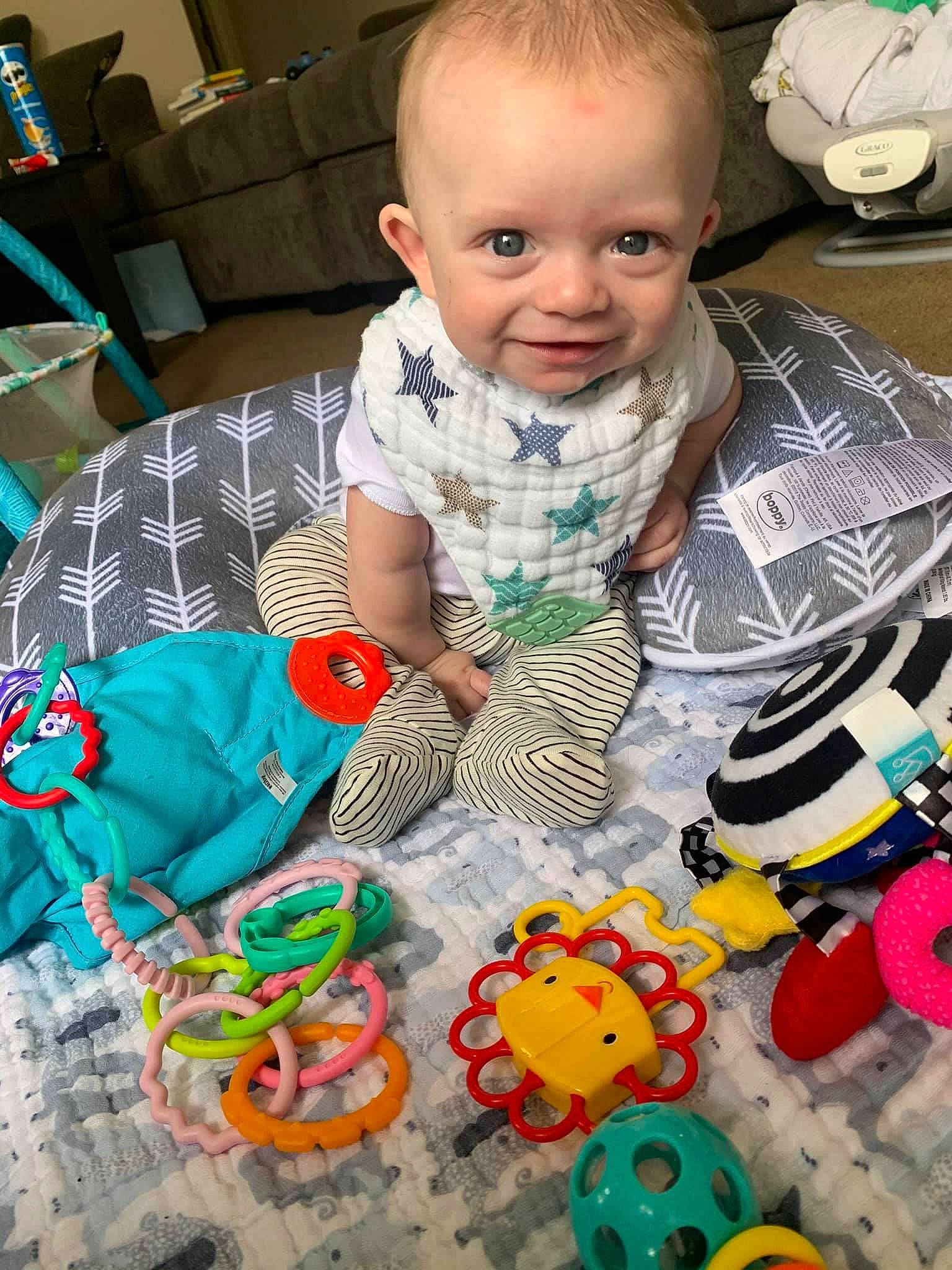 Atticus is registered to the contest to win money with this photo: baby, baby_products, baby_toddler_clothing, baby_toys, cheek, child, flooring, fun, head, linens, mouth, people, person, play, product, room, skin, stuffed_toy, toddler, toy