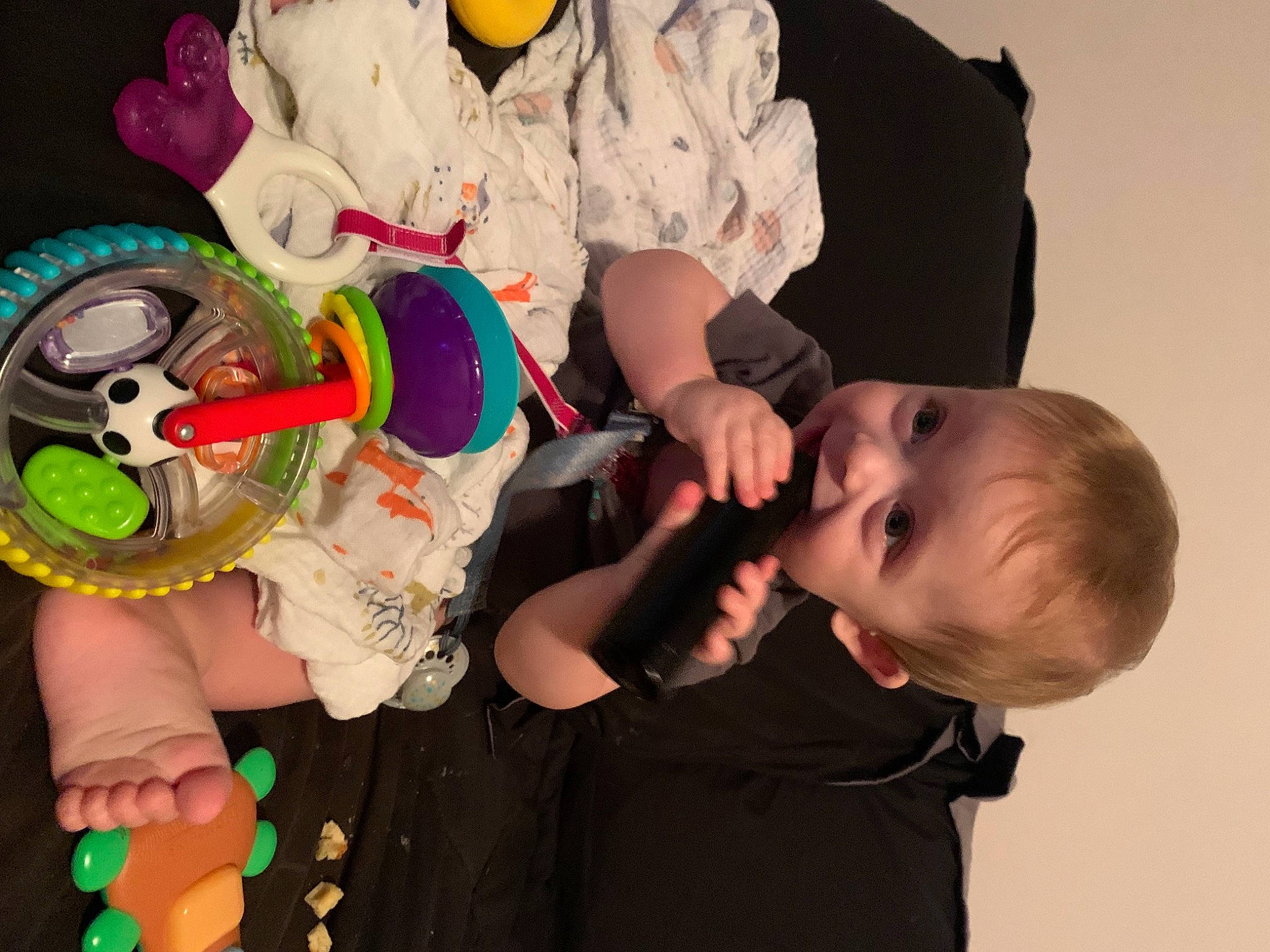 Atticus is registered to the contest to win money with this photo: baby, baby_products, baby_toddler_clothing, child, event, finger, fun, green, hand, happy, headgear, party_supply, person, play, product, sleeve, t_shirt, toddler, toy, wheel
