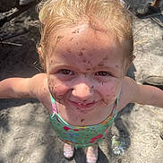 Emily is registered to the contest to win money with this photo: child, girl, mud, dirt, smile, face, outdoor, play, sandy_ground, swimsuit, happy, arms_outstretched, sunlight, headband, blond_hair, messy, sparkly_shoes, summer, fun, portrait