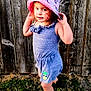 child, girl, hat, unicorn, outdoor, grass, wooden_fence, romper, pineapple_patch, boots, playful, posing, smiling, sunlight, nature, casual_clothing, young, cute, fashion, portrait