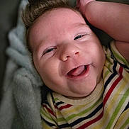 Leo joined the competition — help win amazing prizes! baby, smiling, face, infant, curly_hair, striped_clothing, blanket, happy, close_up, skin, child, cute, cheerful, portrait, one_person, indoors, soft_texture, young, toddler, expression