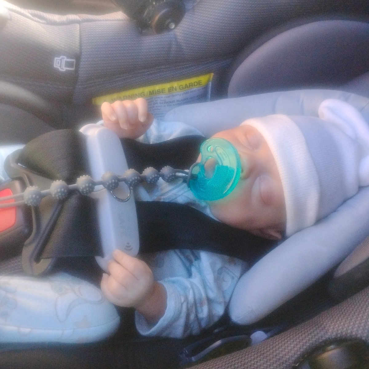 Ashland joined the competition — help win amazing prizes! baby, infant, child, car_seat, car, seatbelt, harness, pacifier, sleeping, lying_down, hands, blue_clothing, blanket, safety, travel, vehicle_interior, portrait, close_up, soft_focus, daylight