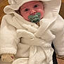 baby, infant, pacifier, white_bathrobe, hood, dog_face_hood, cute, cozy, indoor, floor, wooden_floor, plush, warm_clothing, child, portrait, person, sitting, hands_covered, soft_texture, adorable