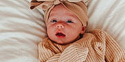Presley joined the competition — help win amazing prizes! baby, infant, child, knitted_sweater, headwrap, bow, blanket, soft_texture, face, portrait, cute, cozy, warm_clothing, lying_down, indoors, closeup, expression, wide_eyes, skin, newborn