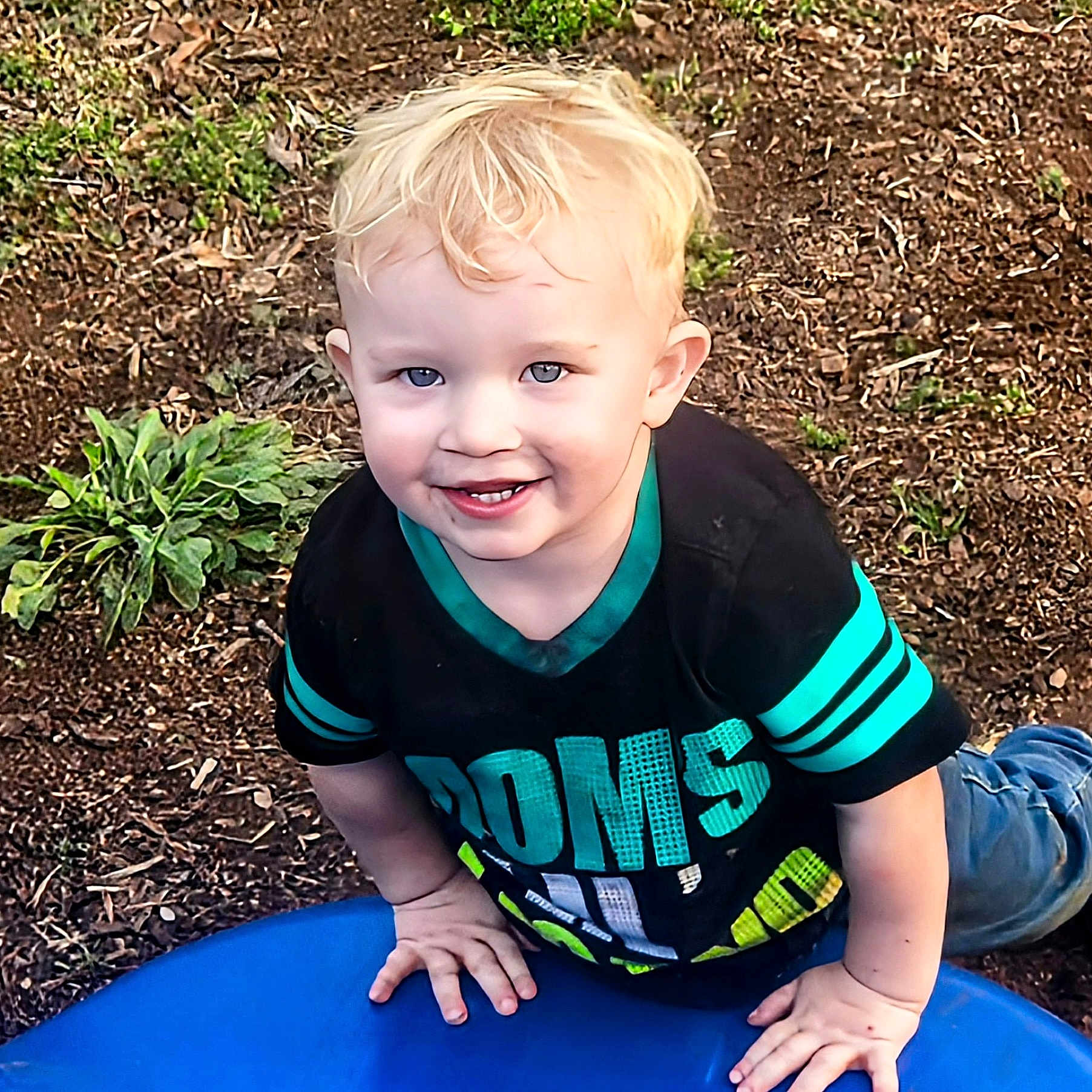 Barret joined the competition — help win amazing prizes! black_shirt, blond_hair, blue_eyes, casual_clothing, child, climbing, daylight, dirt, grass, hands, happy, kneeling, nature, outdoor, playground, smiling, soil, teal_stripes, toddler, young_kid