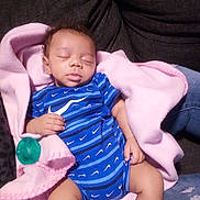 Emil is registered to the contest to win money with this photo: baby, infant, sleeping, blanket, pink_blanket, pacifier, onesie, blue_stripes, couch, sofa, living_room, newborn, cozy, peaceful, closed_eyes, hand, legs, denim, fabric, portrait