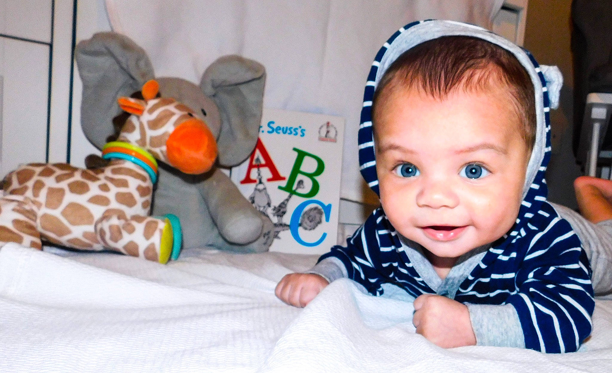 Aden joined the competition — help win amazing prizes! baby, baby_products, baby_sleeping, baby_toddler_clothing, baby_toys, child, ear, fawn, giraffe, giraffidae, person, play, room, stuffed_toy, toddler, toy, tummy_time