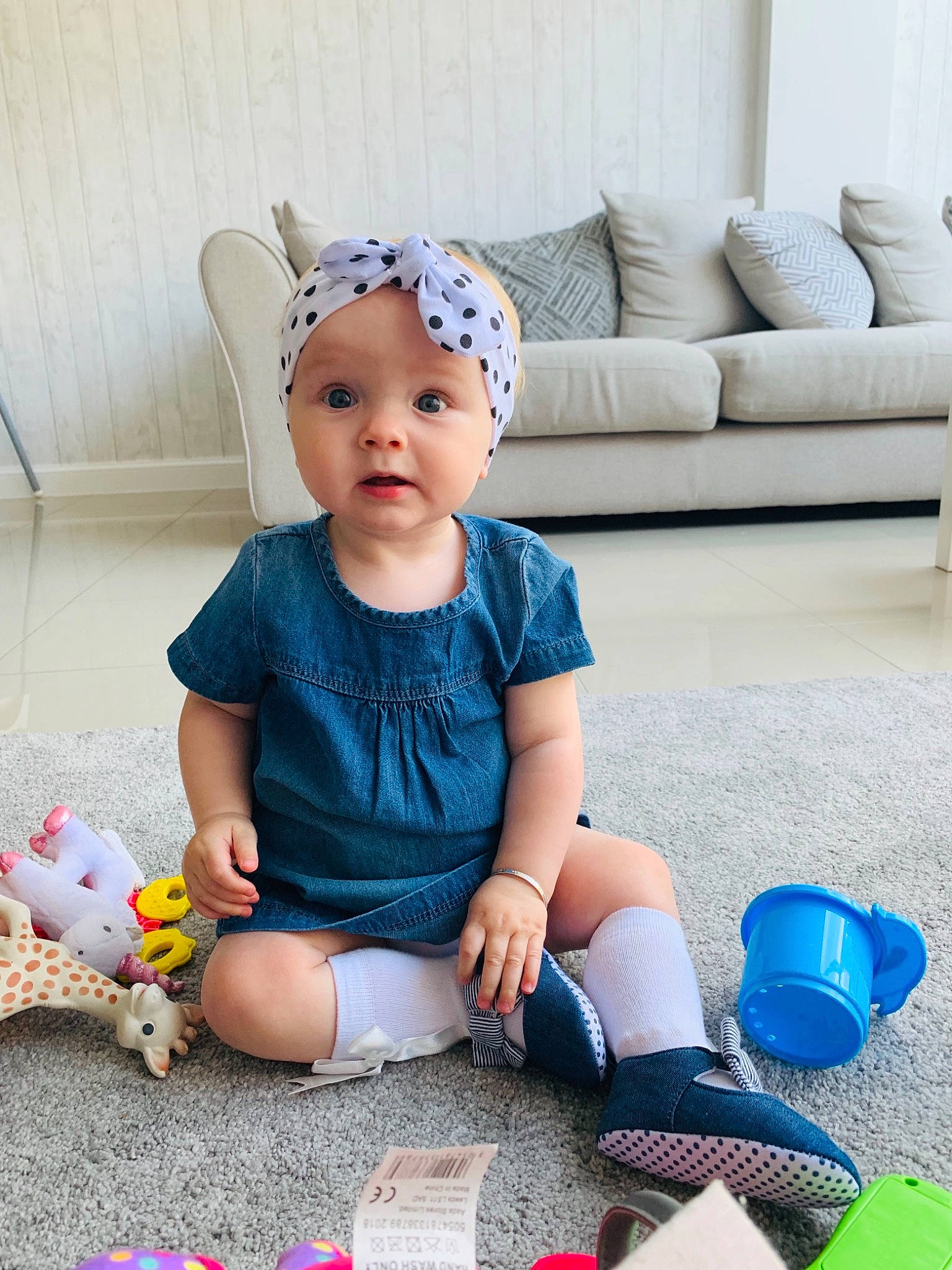Honey is registered to the contest to win money with this photo: baby, baby_toddler_clothing, cap, child, ear, footwear, hair_accessory, headband, headgear, pattern, person, play, product, shoe, sitting, sleeve, toddler