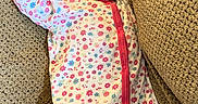Riley is registered to the contest to win money with this photo: baby, sleeping, onesie, floral_pattern, cushion, texture, comfortable, peaceful, infant, closeup, relaxing, indoors, cute, soft, portrait, child, resting, cozy, pink, white