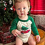toddler, child, baby, christmas, holiday, tree, presents, onesie, green, red, decorations, indoor, portrait, cute, wooden_stool, carrying_tree, festive, smiling, face, hands