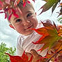 baby, child, face, smile, white_shirt, hand, autumn_leaves, red_leaves, orange_leaves, outdoor, nature, tree, foliage, sky, portrait, person, cute, happy, closeup, seasonal