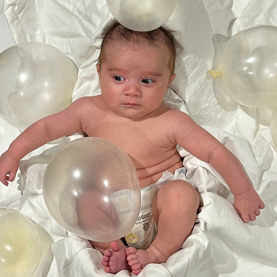Emin joined the competition — help win amazing prizes! baby, balloon, bodypart, clothing, couch, diaper, dress, face, finger, glove, hand, head, inflatable, light, newborn, people, person, photography, portrait, sphere