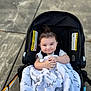 Emin joined the competition — help win amazing prizes! baby, blanket, stroller, smile, child, outdoor, sidewalk, clothing, infant, person, happy, cute, face, hands, black, white, text, script, cozy, seat
