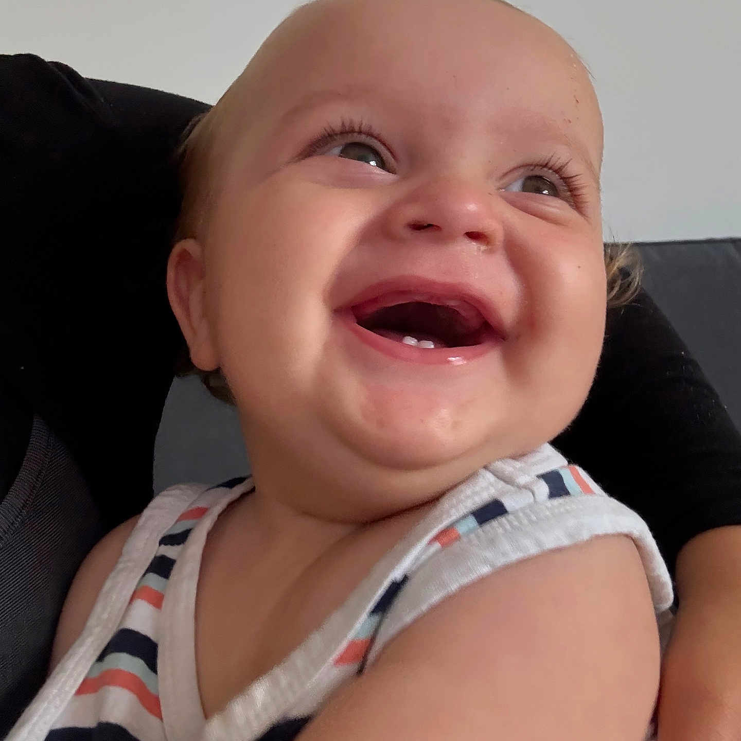 Noah is registered to the contest to win money with this photo: arm, baby, child, closeup, cute, expression, face, hair, happy, human, indoor, infant, joyful, person, portrait, skin, sleeveless, smiling, striped_clothing, teeth