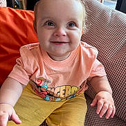 Noah joined the competition — help win amazing prizes! baby, child, smiling, happy, sitting, tshirt, shorts, orange, yellow, indoor, cushion, chair, person, cute, face, hands, eyes, expression, young, portrait