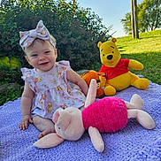 Izabella joined the competition — help win amazing prizes! baby, child, outdoor, grass, plush_toy, winnie_the_pooh, piglet, tigger, purple_blanket, smiling, headband, dress, greenery, sunlight, happy, sitting, nature, toy, cute, playtime