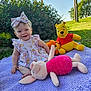 baby, child, outdoor, grass, plush_toy, winnie_the_pooh, piglet, tigger, purple_blanket, smiling, headband, dress, greenery, sunlight, happy, sitting, nature, toy, cute, playtime