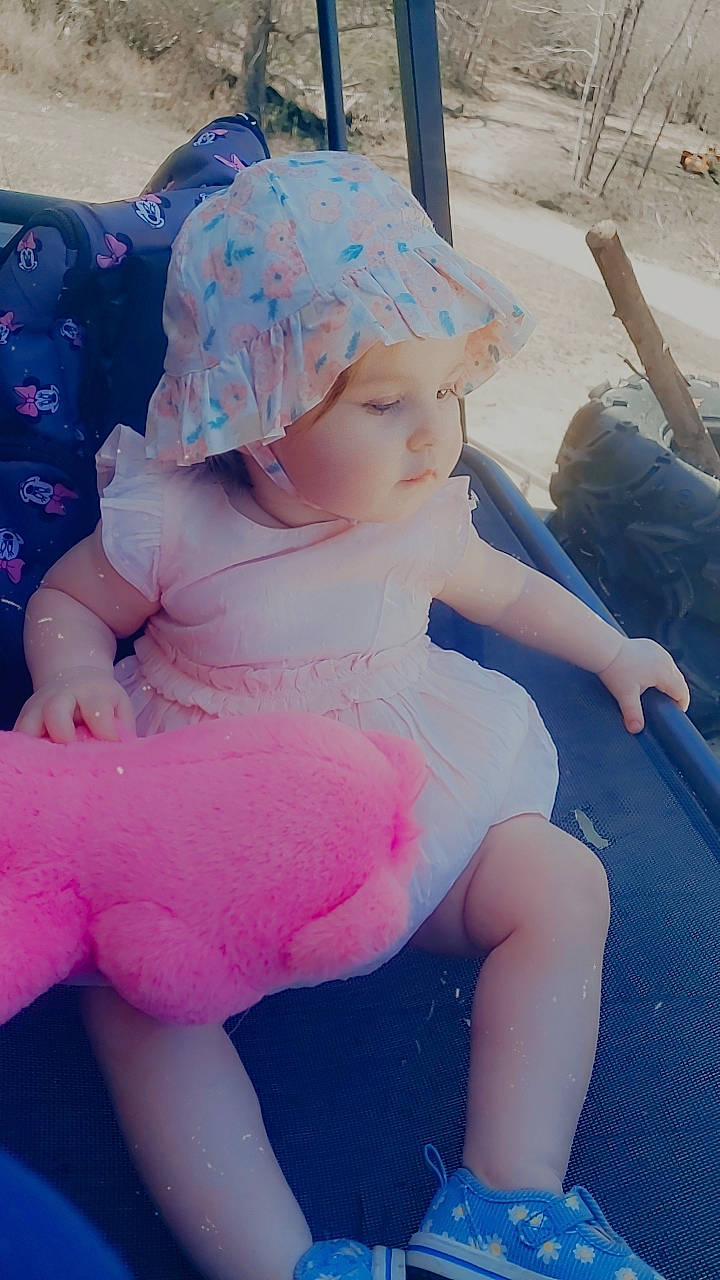 Elizabeth joined the competition — help win amazing prizes! baby_toddler_clothing, cap, child, cool, electric_blue, finger, grass, happy, hat, headwear, human_leg, knee, leg, person, pink, purple, sitting, skin, sleeve, textile