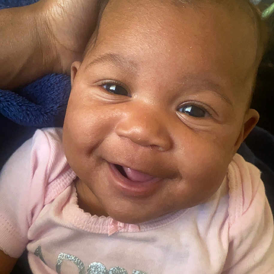 Jonnae joined the competition — help win amazing prizes! baby, babylaughing, bodypart, clothing, cushion, face, finger, hand, happy, head, homedecor, indoors, laughing, mouth, person, photography, portrait, smile, t_shirt, teeth